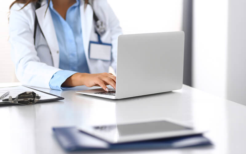 medical professional on laptop