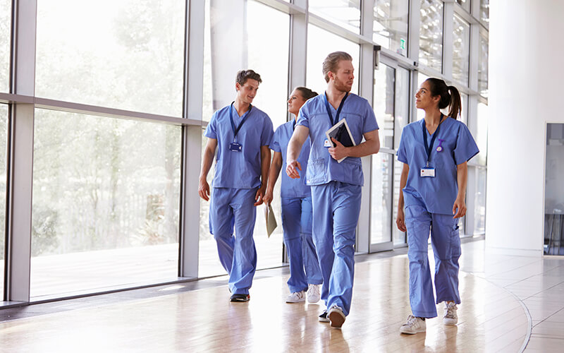 Medical professionals walking through surgery