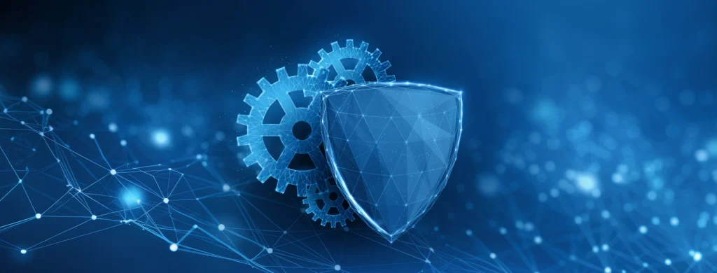 A digital shield with a polygonal pattern positioned in front of two interconnected gears rendered digitally in blue. The elements are set against a dark blue background with glowing network-like connections and blurred points of light. The overall impression is one of security, technology, and interconnectedness.